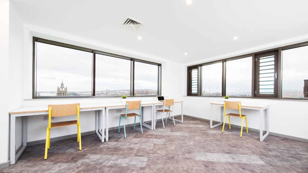 Desks lined against two walls with views over Newcastle